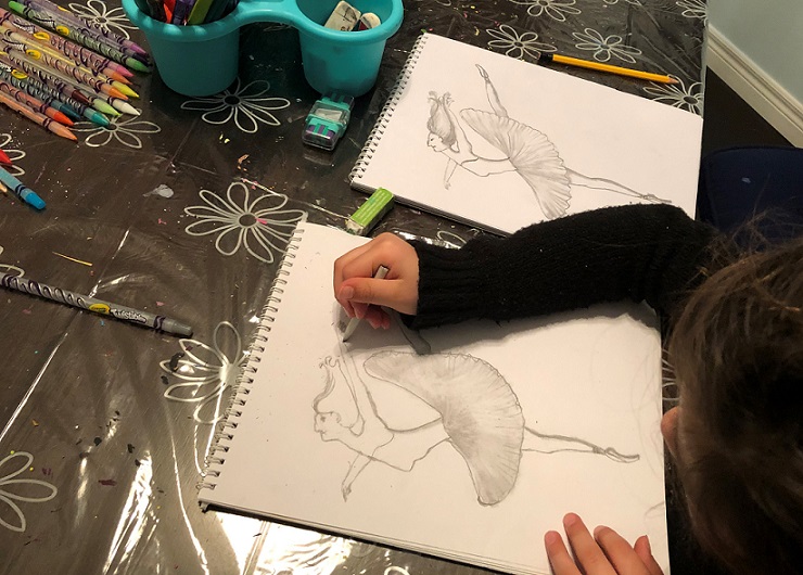 Young girl sketching dancing ballerina.